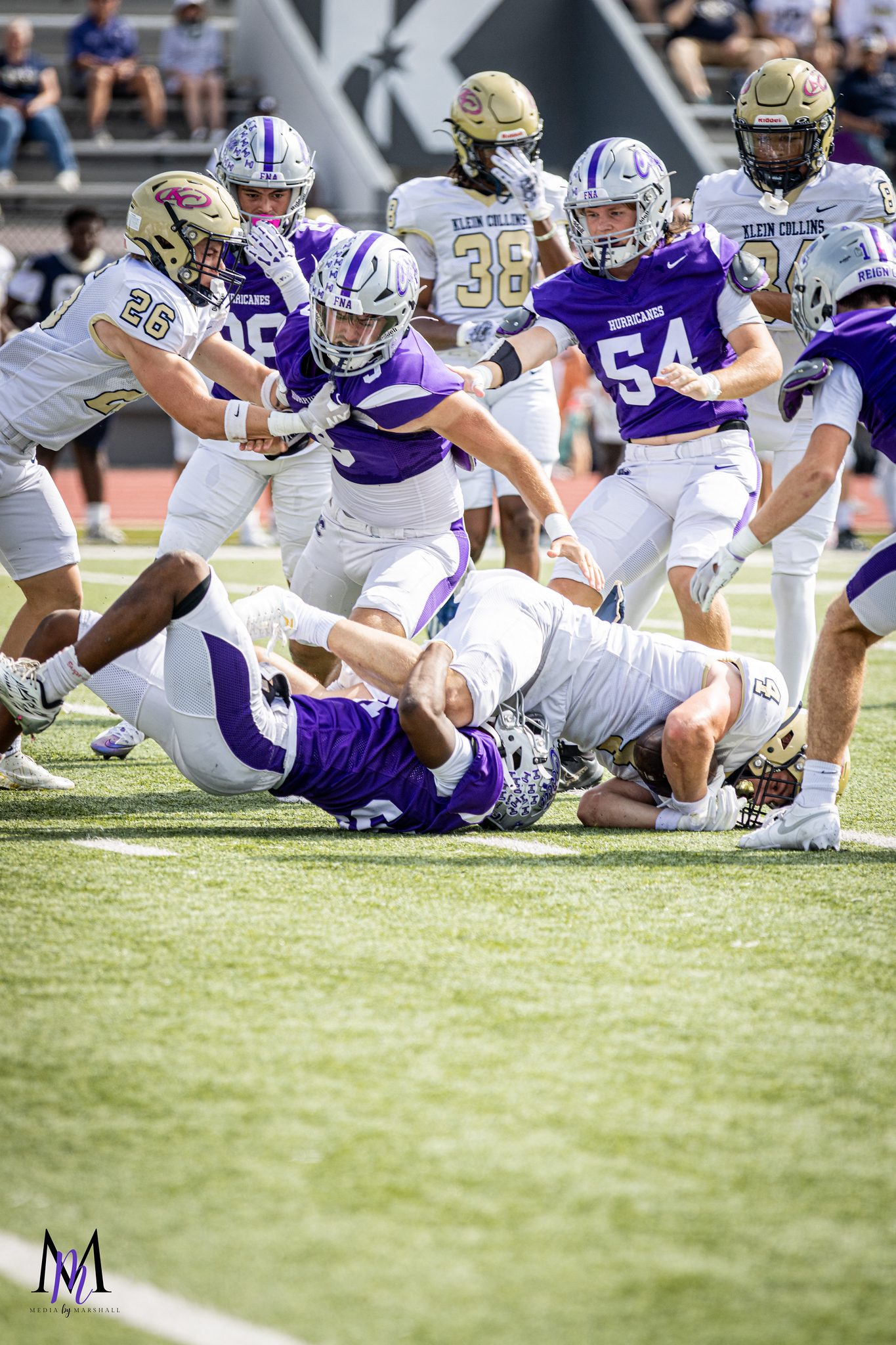 The Hurricane defense swarms a Collins ball carrier