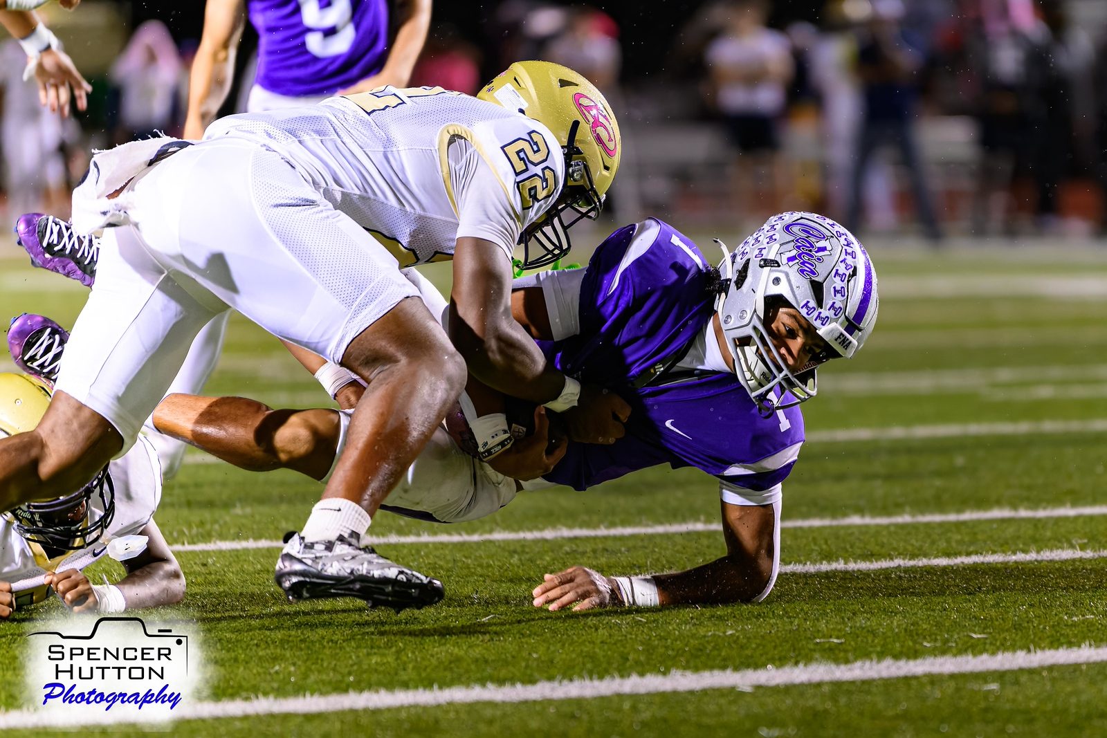 Junior Earl Oguinn Jr. is dragged down by a Collins defender
