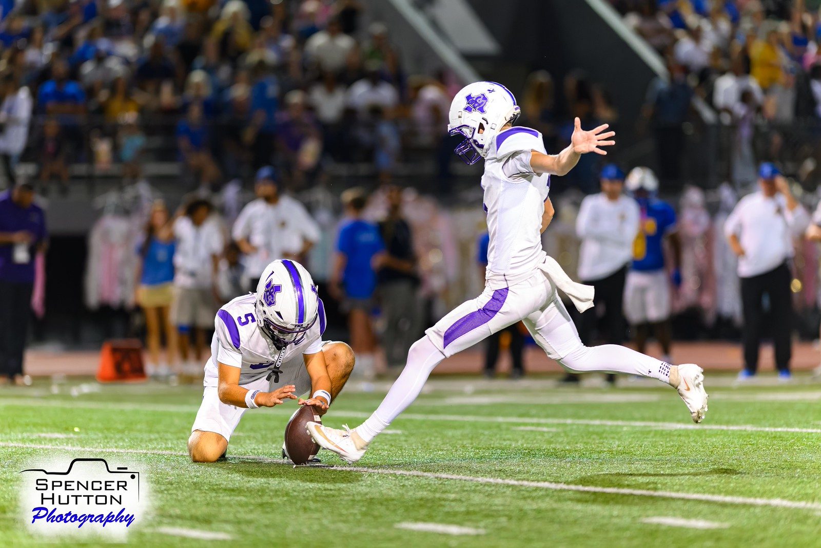 Trey Reyes holds for a Cain extra point attempt